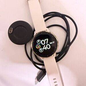 Elegant Gold and Ivory Smartwatch with Charging Dock